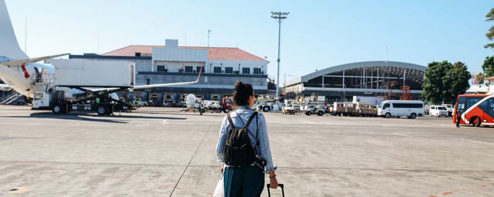 Woman standing on tarmac at airport